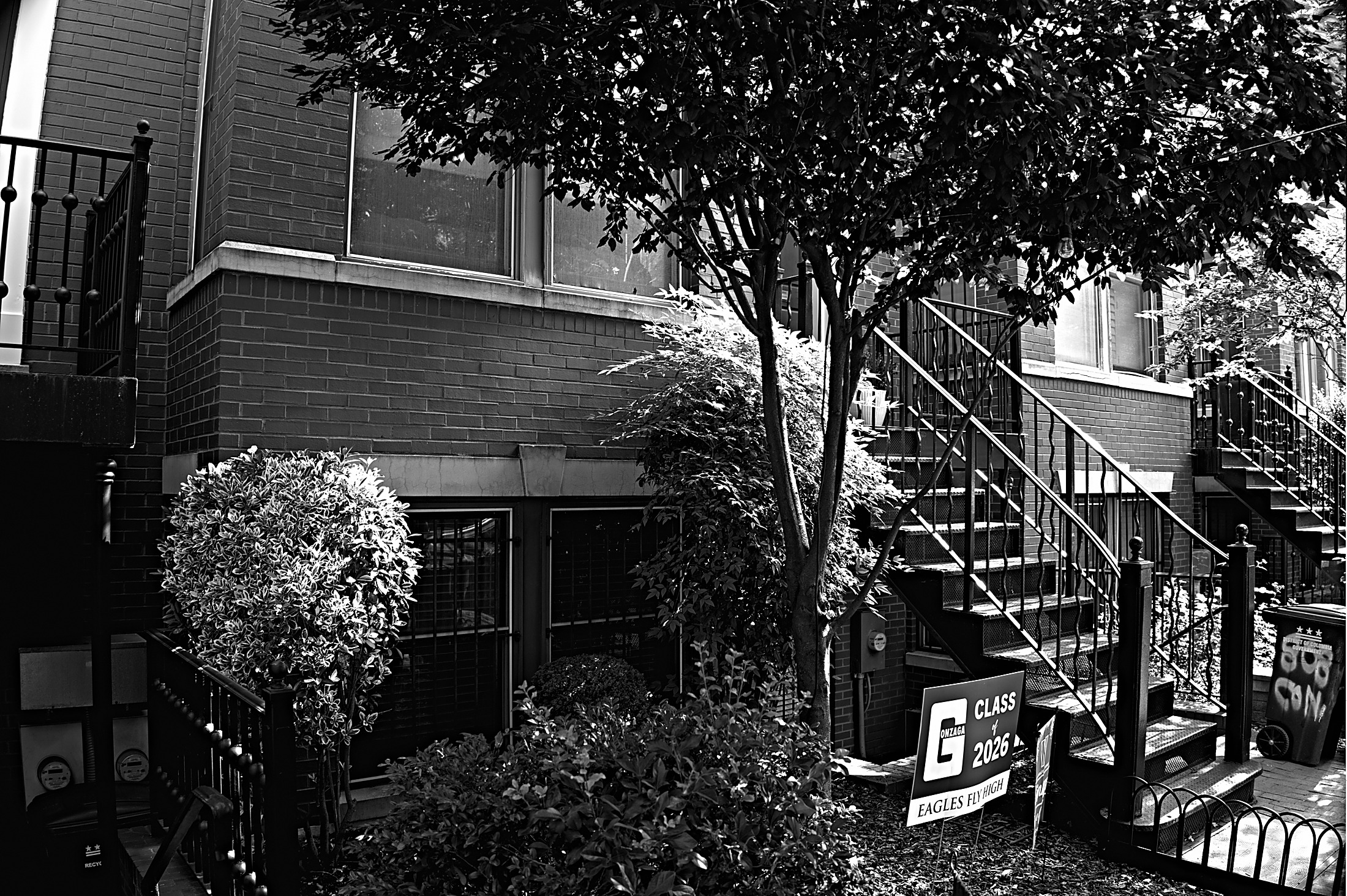 A Class of 2026 graduation yard sign outside a rowhouse